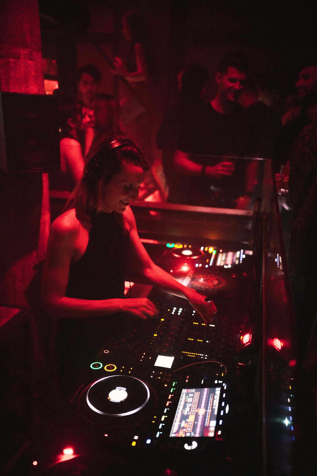 Goutier smiling at the CDJs in a Barcelona club